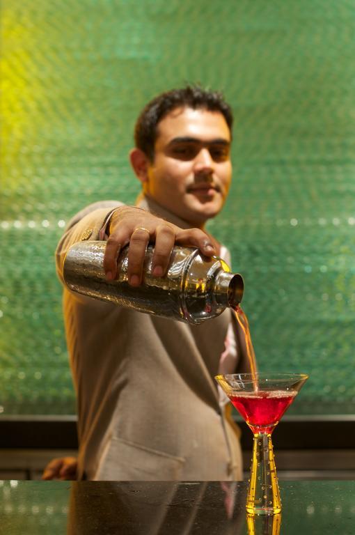Vivanta Hyderabad, Begumpet Exterior foto A bartender pouring a drink